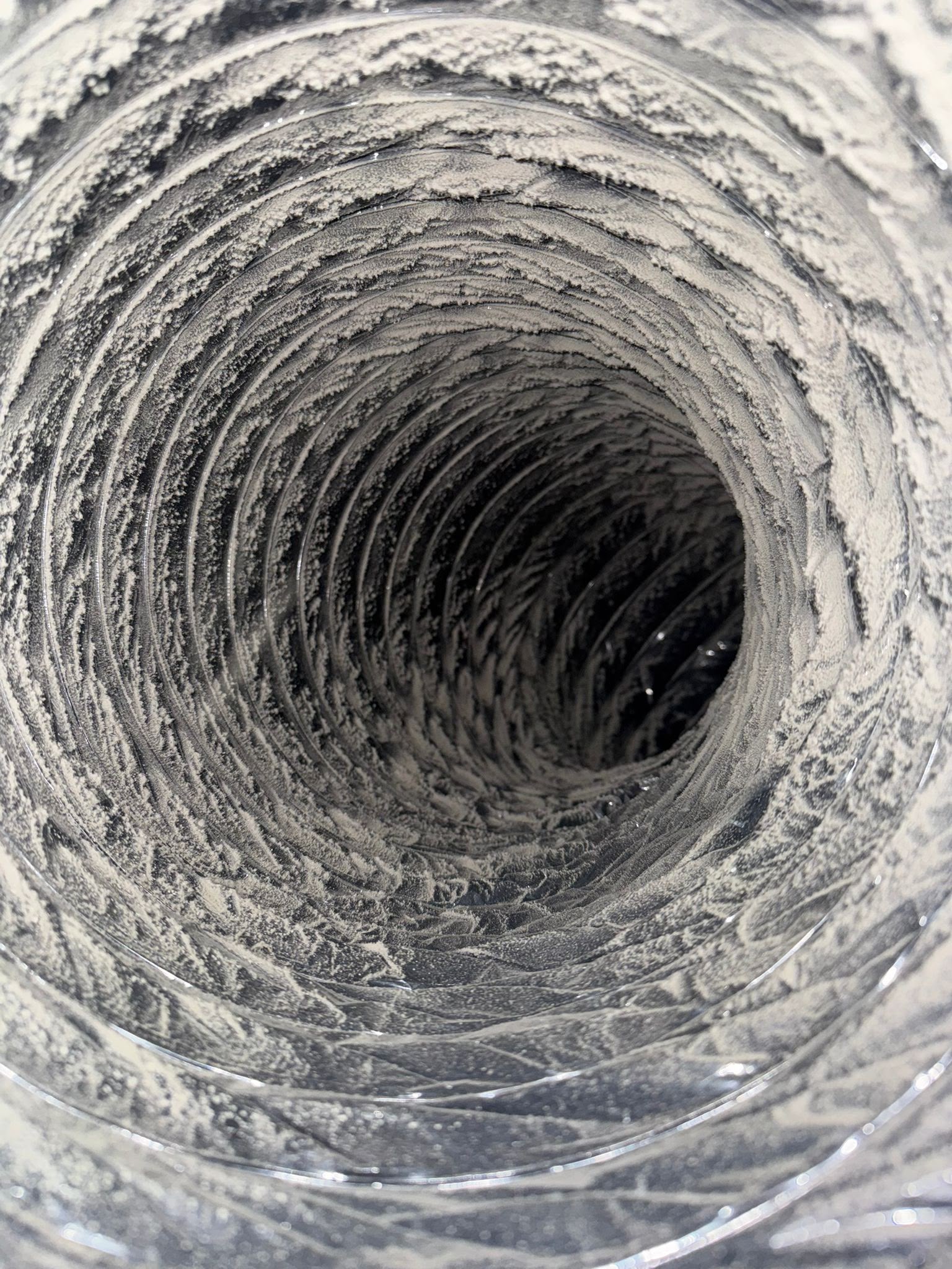 Inside a dryer vent duct with heavy lint buildup, a leading cause of dryer fires in Tampa Bay FL homes
