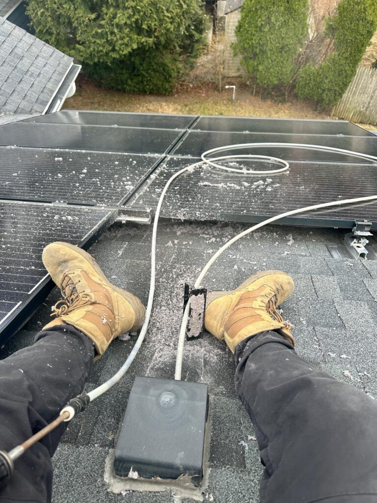 Sunshine Duct Cleaning technician accessing a rooftop dryer vent exterior cap on a Tampa FL home
